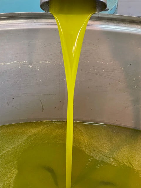 green new oil pouring from the spout.